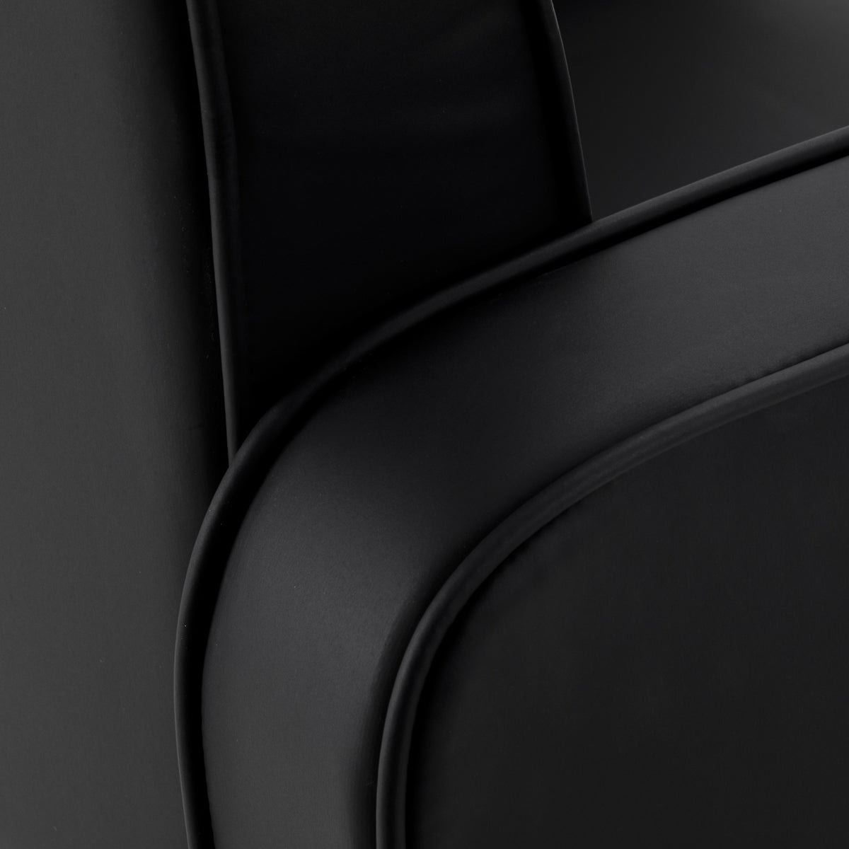 Black Omega Andromeda hairdressing chair with adjustable headrest and armrests, featuring sleek modern design.