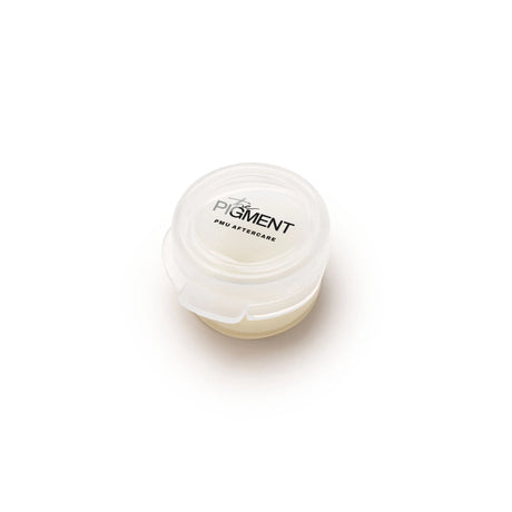 Set of 25 The Pigment Aftercare Balm tubes for skin healing and aftercare, featuring natural ingredients and compact packaging.